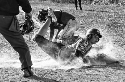 SAFE! Jacob Cook of the Shead Tigers slides safely into home plate during a high school baseball game against the Narraguagus Knights on May 9. Narraguagus ende