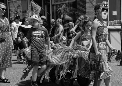 Parading through Eastports waterfront is one of the patriotic entries in the Doll Carriage, Wagon, Bike and Trike Parade. See pages 13 through 17 for coverage of the celebration. (Don Dunbar