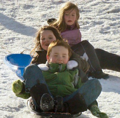 THRILL-SEEKING SLEDDERS Jude and Veda Zanoni (riding up front) and Winnie French (in back) took to the slopes at Cobscook Bay State Park during the Winter Family Fun Day on January 28.(Chess