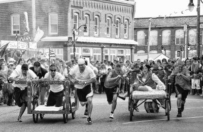 RACING for the fastest time during the Eastport Pirate Festival bed race were teams representing the U.S. Coast Guard and the New Friendly Restaurant, which won the race. (Don Dunbar photo S