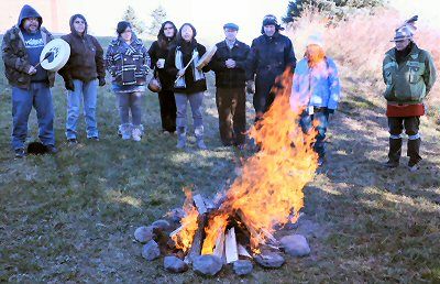 A HEALING SONG is sung by Larry Robichaud (at left) after the lighting of the sacred fire at the beginning of the three-day visit to Sipayik by the Maine Wabanaki-State Child Welfare Truth a
