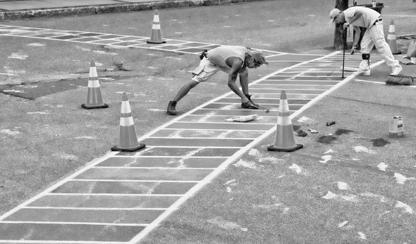 REPAINTING the rainbow crosswalk in downtown Eastport after it was vandalized on the night of July 13 is a crew from JP Painting of Pembroke, who volunteered and were at work the day after t
