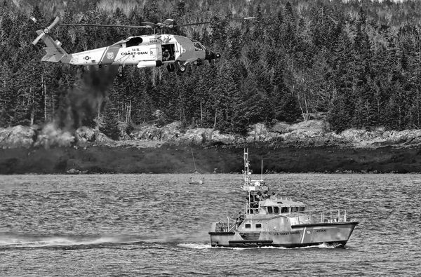 CONDUCTING hoisting drills in Passamaquoddy Bay on March 24 were U.S. Coast Guard Station Eastport's 47-foot motor lifeboat and a Coast Guard helicopter. (Don Dunbar photo)