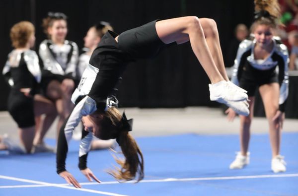 EXECUTING A BACKFLIP is Izzy Clark of the Eastport Panthers during the Maine State Junior High School and Elementary Cheering Championships in Bangor on March 3. Washington County teams perf