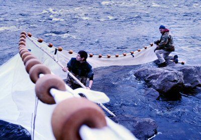 PREPARING an elver fyke net for a night of fishing on the St. Croix River are Passamaquoddy tribal members Kyle Moore and his father, Fred Moore III, who is coordinator of the tribe's Fisher