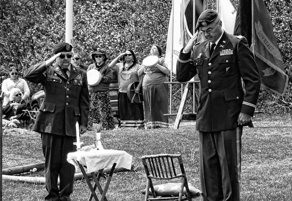 SALUTING after the presentation of a U.S. flag to honor a veteran, as would be done during a military funeral, are U.S. Army veteran James Pearson and retired Lt. Colonel Andrew Pottle, U.S.