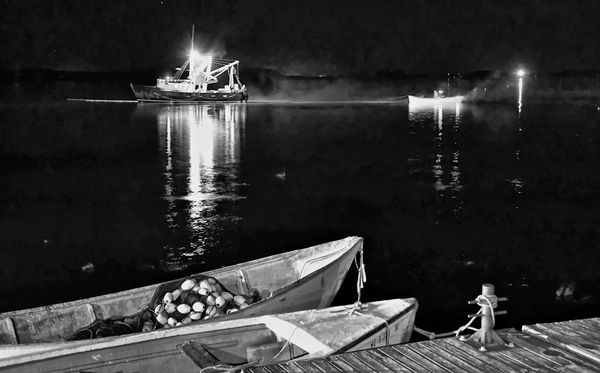 SEINING FOR HERRING off the Eastport breakwater on the night of August 17 is the crew of the Jenny Rose, a purse seiner owned by Earl Small. (Don Dunbar photo)