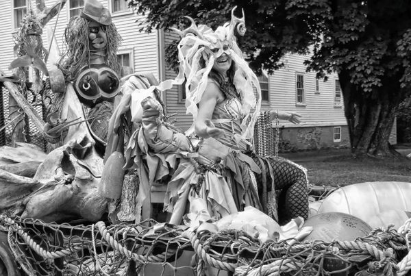 SURFING THE WAVES created on Lubec artist Chuck Kniffen's beach trash puppet float is mermaid Manuela Brice during the Mermaid Parade in Eastport on August 5. See this issue for coverage of 