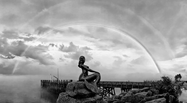 A DOUBLE RAINBOW forms over the mermaid sculpture on the Eastport seawall after a recent thunderstorm. (Don Dunbar photo)