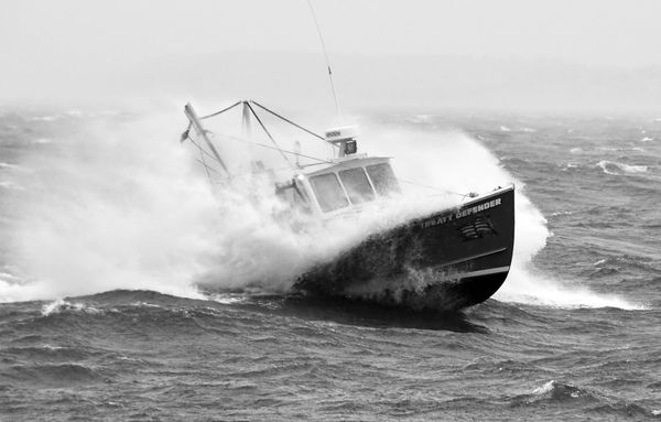 BREAKING THROUGH THE WAVES in the waters off Eastport on a rainy and windy morning on December 11 is the scallop dragger Treaty Defender, owned by Adam Newell of Sipayik. The local scallop f
