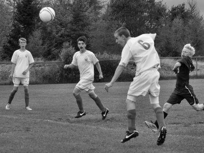 USING YOUR HEAD. John Cushing of Shead High School heads the ball in to score a goal against East Grand during a soccer game on September 15. The Shead Tigers, with a record of 9-0-1, have n