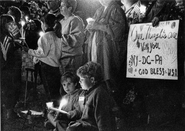 GATHERING TOGETHER for a 9/11 memorial vigil in Calais on September 14, 2001, were people from all over the Quoddy area, including Tessa Claridge and Angelica Underhill, who made the thought