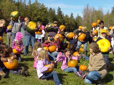 LIFT YOUR PUMPKINS and make a scary face! Students from the Whiting Village School visited the Ernest James vegetable farm in Charlotte for their annual pumpkin-picking fest on Friday, Octob