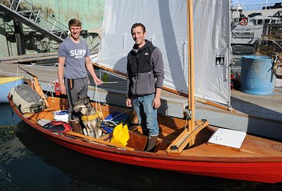 FINISHING THEIR JOURNEY from Portland to Eastport in a 17-foot Swampscott dory on October 8 are Paul Moughamian (left), Jayme Schroeder and Echo, a husky who stayed still during the trip. Th