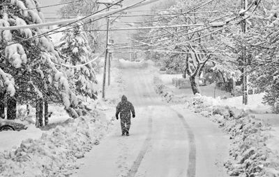 HEADING UP MARCH HILL, as winter continues into spring, this walker in Eastport’s South End looks over the snowfall after the March 13–14 storm. (Edward French photo)