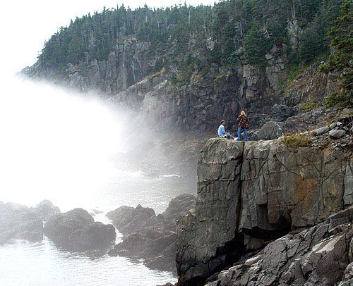 POSING ON THE NARROW LEDGES at Gulliver's Hole in West Quoddy Head State Park, two September tourists are among many who are willing to risk a dangerous tumble to enjoy a stunning photo-op. 