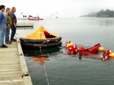 TRYING OUT SURVIVAL SUITS at the Lubec town landing on Saturday, September 25, were participants in a training course for commercial fishermen on survival skills and safety equipment found o