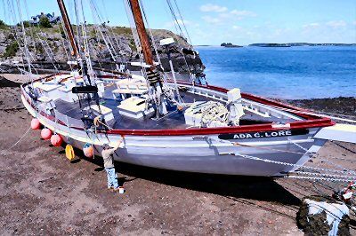 GIVING the Eastport windjammer Ada C. Lore a fresh coat of paint is owner Butch Harris, as it's beached at Martin's Dock, next to the ferry landing in Eastport. The schooner is now beginning