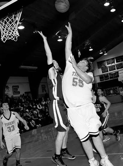 GOING UP FOR A SHOT and scoring is Mac Hood of Shead High School in a boys' varsity basketball game against Islesboro played in Eastport on January 19. Shead won 51-47 and now has a record o