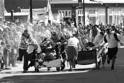 BREAKING OUT between two Pirate Bed Race teams is a water balloon fight. The Boat School team "Foggy Bottom" (left) eventually went on to win the race, held as part of the Eastport Pirate Fe