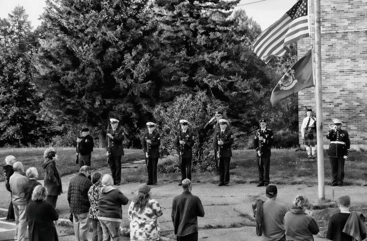 PAYING TRIBUTE as taps is played are honor guard members and the crowd attending the 9/11 ceremony held outside Shead High School in Eastport on the 20th anniversary of the terrorist attacks
