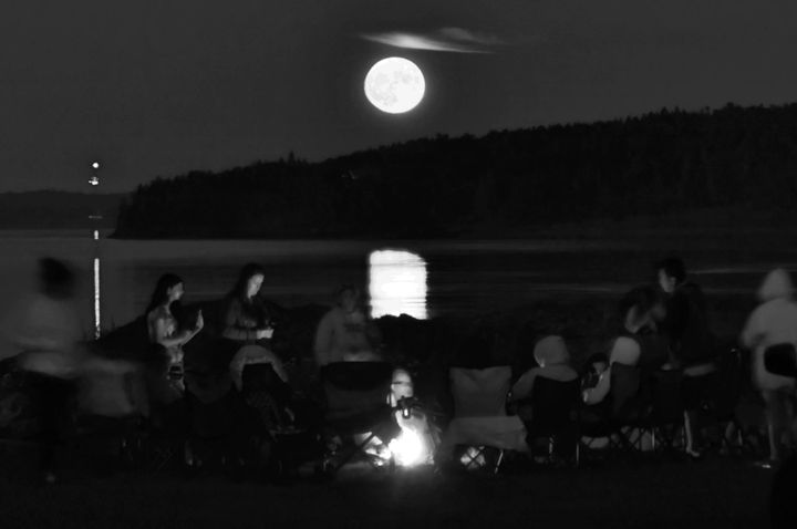 PASSAMAQUODDY TRIBAL MEMBERS held a Full Moon Ceremony with singing and drumming at Split Rock, Sipayik, during the full moon on July 13. (Don Dunbar photo)