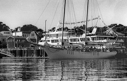 EASTPORT'S SHIP COMES IN. Going out on the schooner Halie & Matthew, cruise ship passengers sail by their vessel, the Spirit of Nantucket, docked at the Eastport Fish Pier. Edward French pho