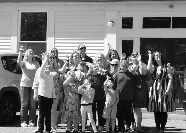 STUDENTS, TEACHERS and staff wave goodbye on June 10 as the Charlotte Elementary School closes its doors one last time. See article about final day of school in this issue. (Eileen Clark pho