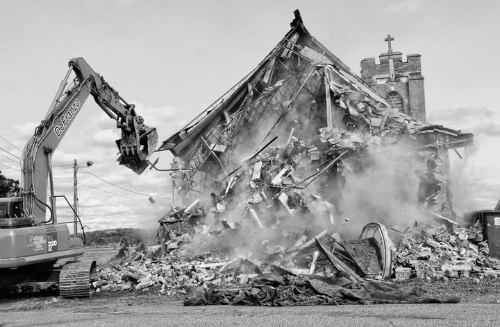 FAREWELL TO A COMMUNITY LANDMARK. The nearly 100-year-old St. Ann's Church at Sipayik was torn down on September 20 by DeFranzo Demolition Corporation. A small crowd watched, with a number e