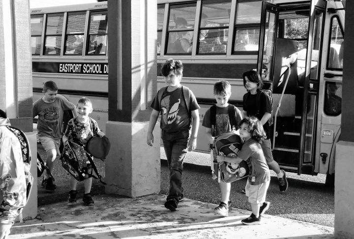 HEADING BACK TO SCHOOL after summer vacation are these Eastport Elementary School students coming off the bus for the first day of school. (Edward French photo)