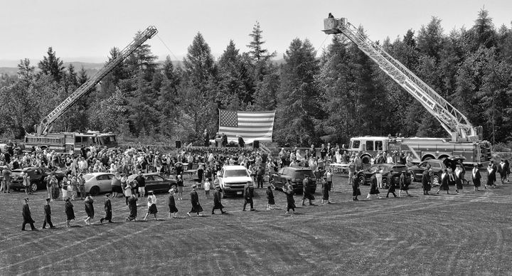 MARCHING to the stage for the outdoor graduation ceremonies on June 4 are the members of Shead High School's senior class. (Don Dunbar photo)