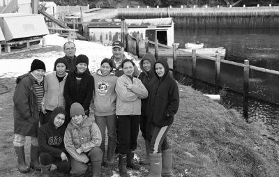 NINE OF THE 24 FILIPINO WORKERS at the Paturel International plant at Northern Harbour, Deer Island, pose in front of the world's largest lobster pound, which is part of the company's operat