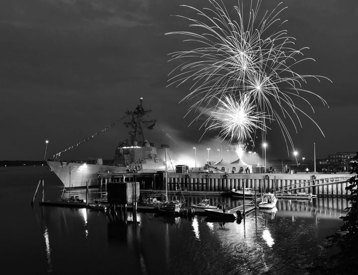 EASTPORT'S GRAND FIREWORKS DISPLAY over the USS Oscar Austin capped the Fourth of July celebration. An eager youth take part in the penny scramble, while Tucker Mitton splashes into the wate