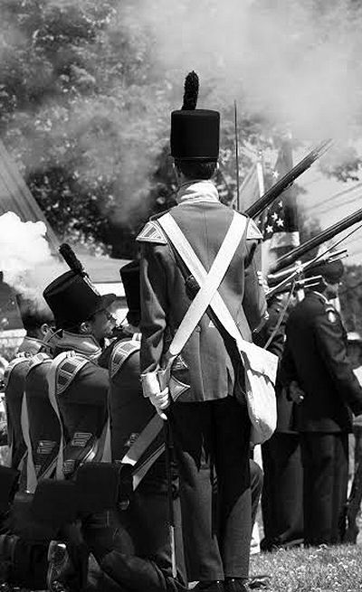 THE BRITISH ARE HERE! Soldiers from the Halifax Citadel, wearing the uniforms of the 104th Regiment of Foot, fire their muskets as part of the commemoration of the 200th anniversary of the c