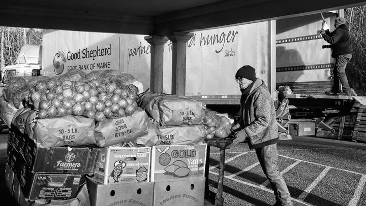 HELPING DELIVER PALLETS OF FOOD to the Labor of Love Food Pantry in Eastport on January 8 are food pantry volunteer George 'Buster' Townsend and Don Arsenault of the Good Shepherd Food Bank.