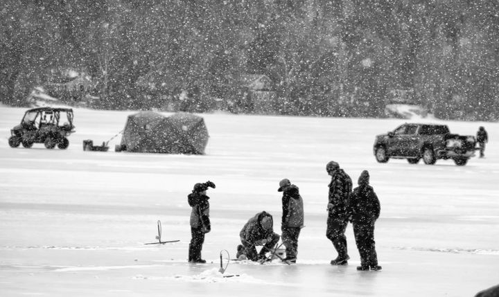 SNOW FALLS during the Winter Family Fun Day at Round Pond in Charlotte on Saturday, February 19, but everybody stayed with hopes of getting the largest fish. The event, which included a fish