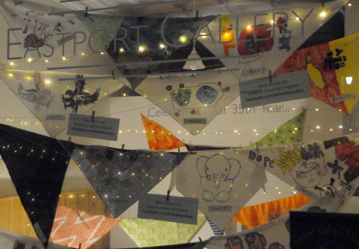 COLORFUL BANDANNAS, hand-painted by Eastport students in grades 3'8, are on display in the windows of the Eastport Gallery. A silent auction to benefit the Eastport schools' art program is o