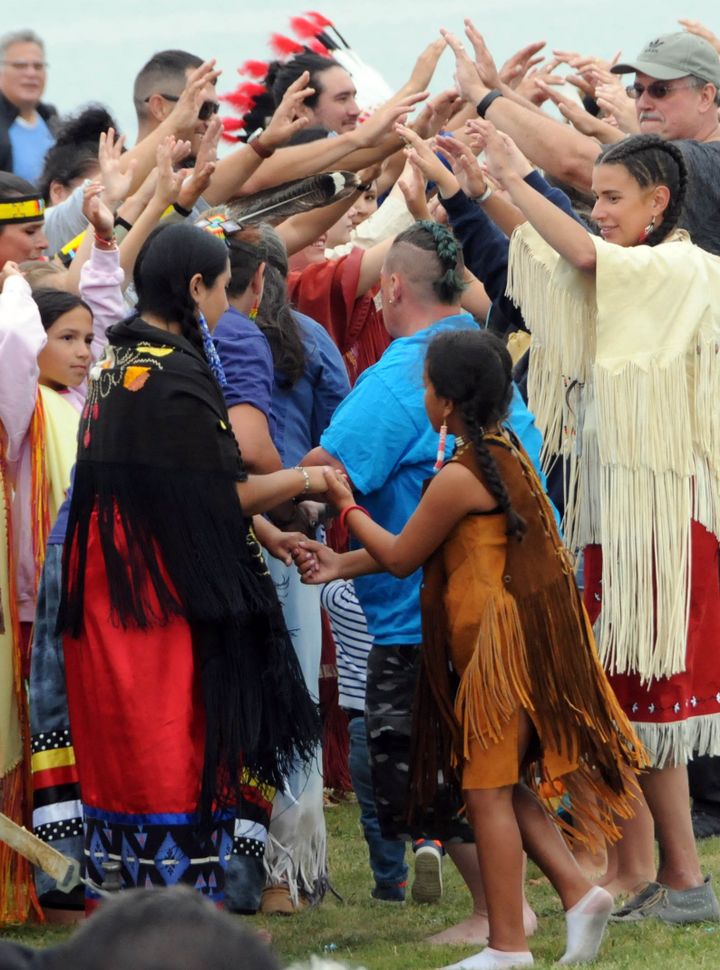 FORMING AN ARCH with their hands that dancers went under were these participants in one of the dances during the Passamaquoddy Days celebration at Sipayik. (Edward French photo)