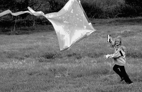 GO FLY A KITE! Madison Greenlaw was among the children flying kites during a windy Carnaval Kite Day at The Cornerstone Baptist Church in Eastport May 10. The children also played games and 