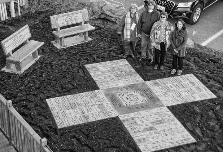 LEGACY PARK, located on a city-owned lot next to The Commons in Eastport, is nearly completed, with the placement of granite pavers honoring people and events. Shown are coordinator Linda Go