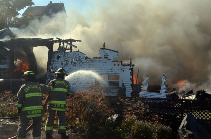 FIRE ENGULFS the H D and Sons Seafood warehouse located on the Lubec waterfront on October 1. The Campobello fire department provided mutual aid to the Lubec department, bringing several tru