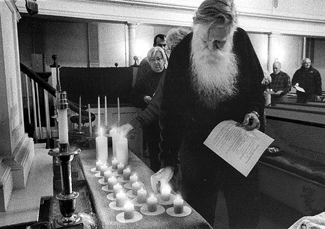 IT IS BETTER TO LIGHT ONE CANDLE... Placing his candle on the altar in the International Day of Action to Stop Global Warming service in Eastport is Davis Pike Grady. Held on December 3 at t