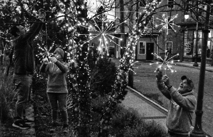 GETTING READY FOR THE HOLIDAYS. A merry band of elves, including Aaron Matthews, Keri Matthews and Jim Riccio, have been decorating downtown Eastport during the past two weeks. See article i