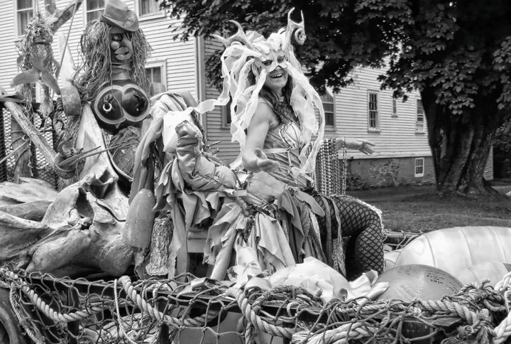SURFING THE WAVES created on Lubec artist Chuck Kniffen's beach trash puppet float is mermaid Manuela Brice during the Mermaid Parade in Eastport on August 5. See this issue for coverage of 
