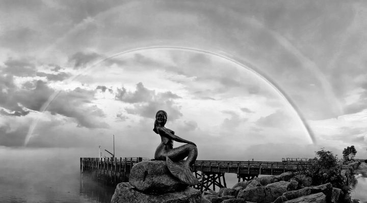 A DOUBLE RAINBOW forms over the mermaid sculpture on the Eastport seawall after a recent thunderstorm. (Don Dunbar photo)