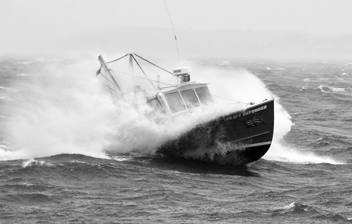BREAKING THROUGH THE WAVES in the waters off Eastport on a rainy and windy morning on December 11 is the scallop dragger Treaty Defender, owned by Adam Newell of Sipayik. The local scallop f