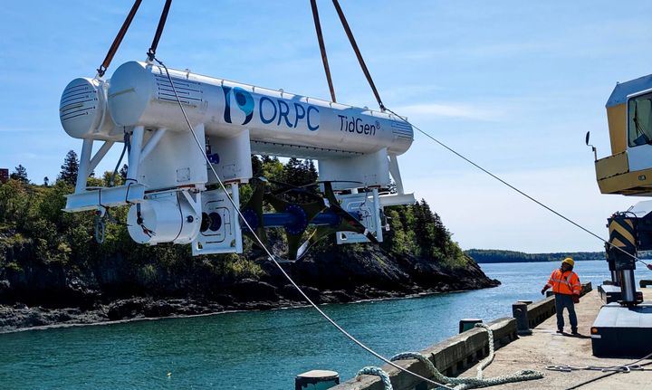 ORPC'S SINGLE TURBINE TIDGEN DEVICE is lowered into the ocean at Estes Head, Eastport, on May 22 in preparation for testing in Cobscook Bay. (Photo courtesy of ORPC)