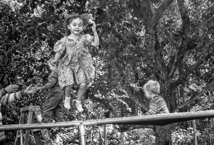 JUMPING FOR FUN are Lizzie and Kevin Wiknik of Connecticut and Jamie Brown of Pembroke at the fall festival held by Hope's Haven farm in Pembroke on October 8. (Edward French photo)