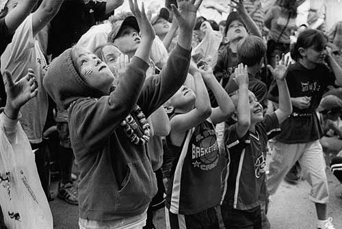 WATCH YOUR HANDS! They are certainly necessary if you want to catch some coins during the annual Penny Scramble on July 4 in Eastport. However, Mary Jackson (bottom left), commander of the U