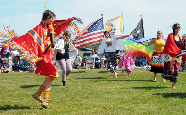 THE FANCY SHAWL DANCE drew many participants in colorful costumes during the Peskotomuhkat ceremonial dances at Split Rock, Sipayik, on August 11. See this issue for an article about the cel